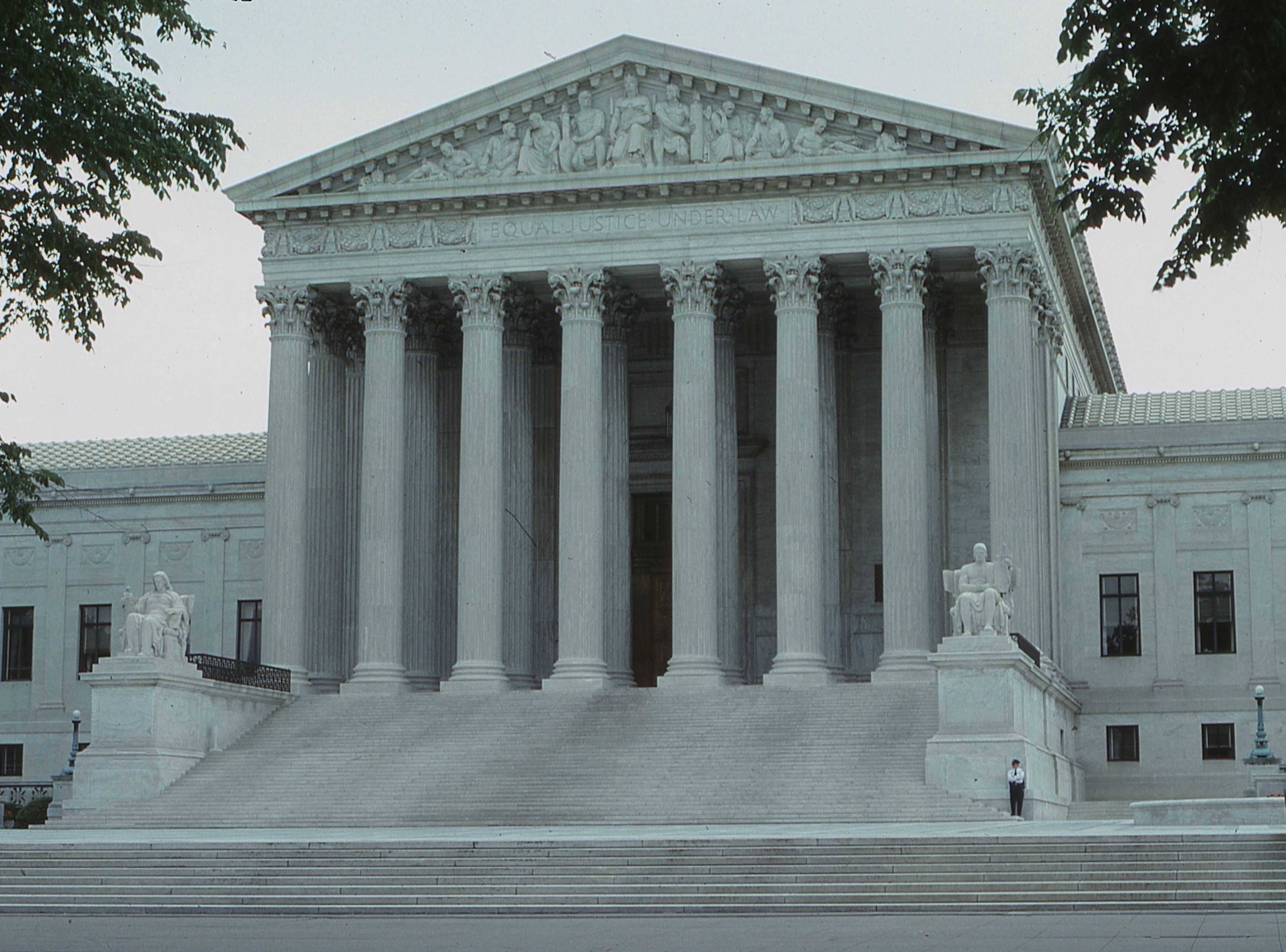 Facade of a supreme court building with classical columns where major litigation is heard