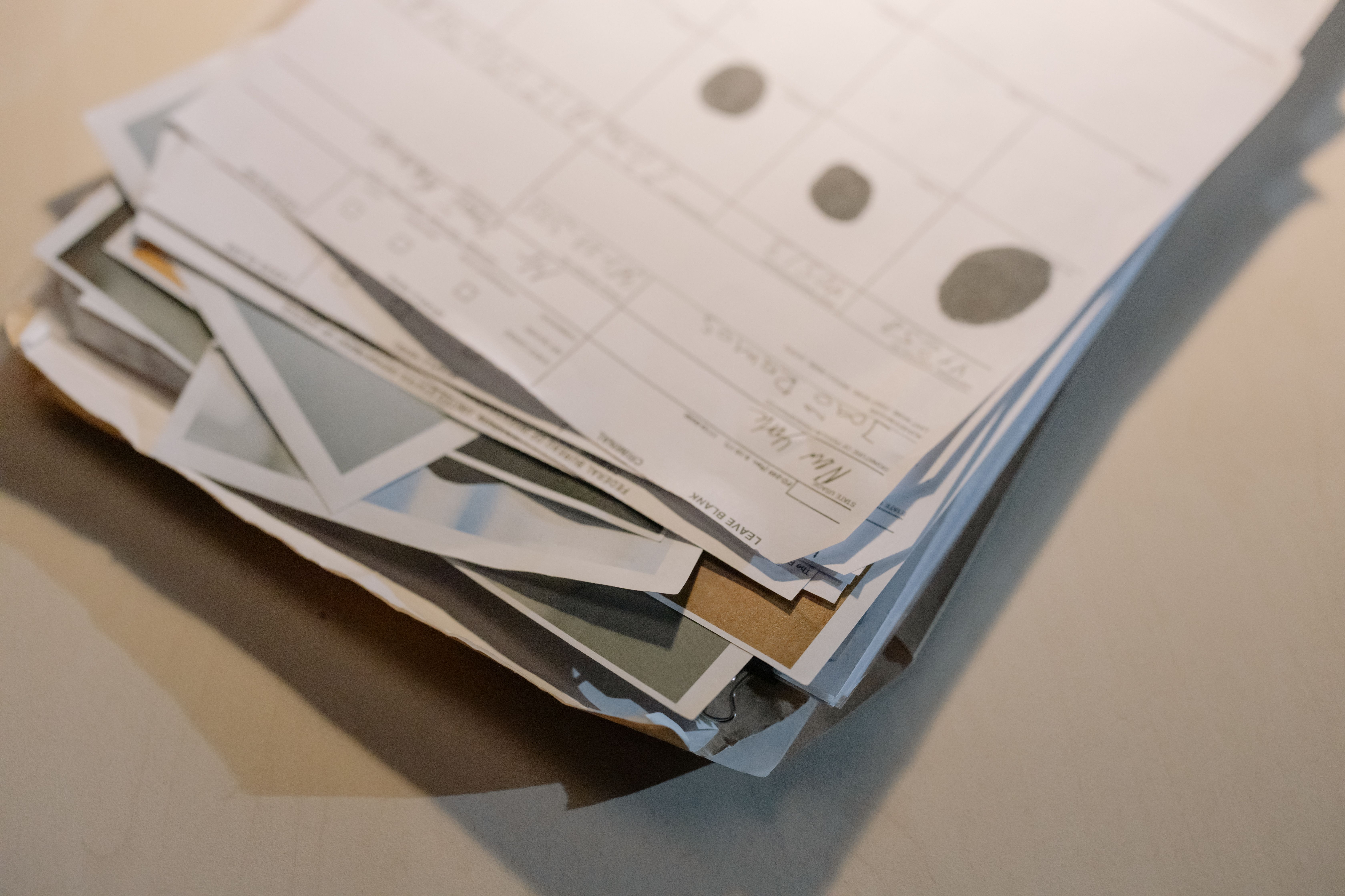 Close-up of a large stack of legal documents and paperwork on a desk from a litigation case