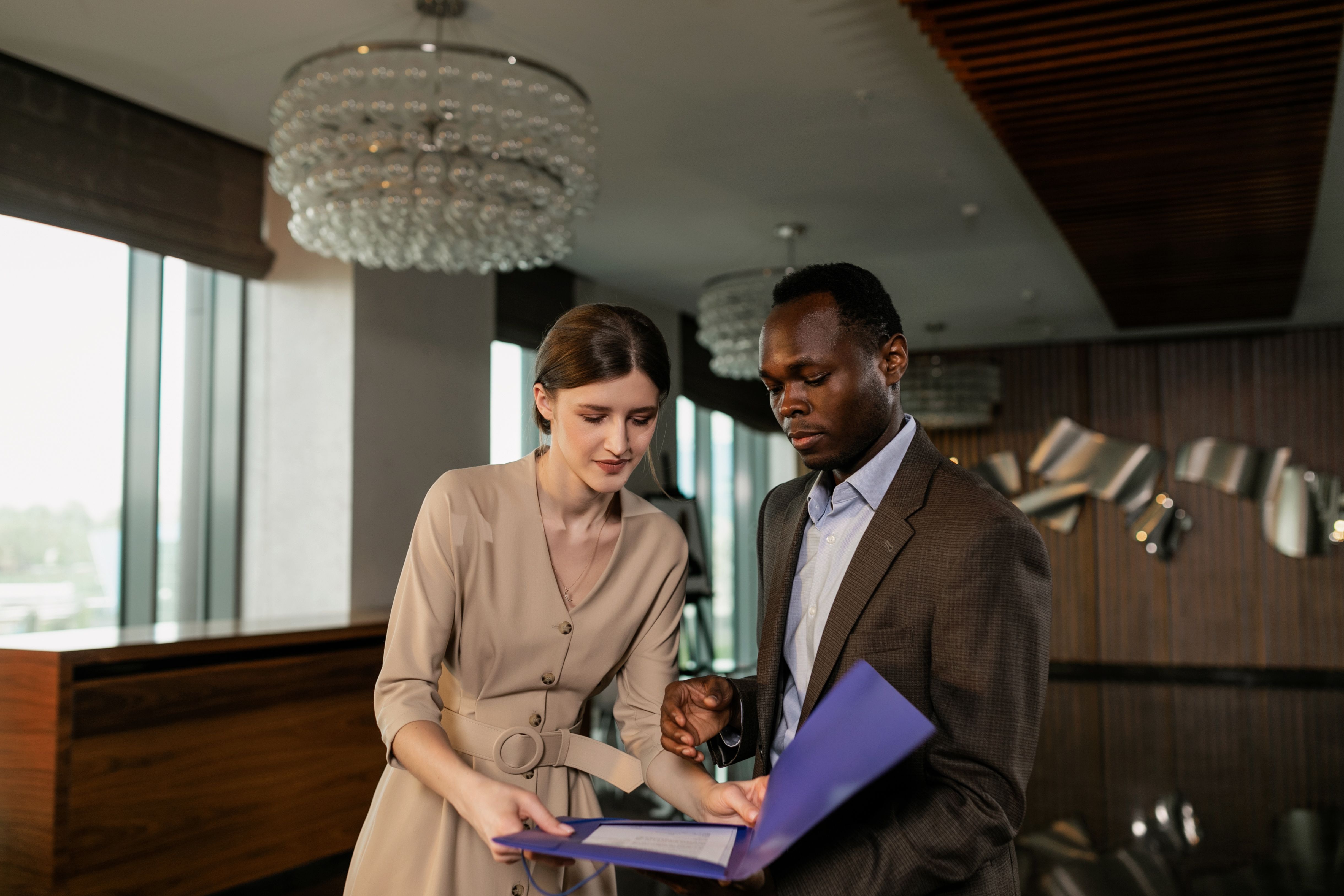 Two lawyers reviewing legal documents during a meeting about a large-scale lawsuit